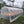 Coffee drying beds under a protective tarp.