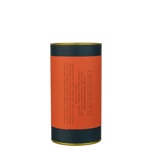 A navy blue cylinder with a red label describes the roasted coffee beans.