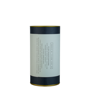 A navy blue cylinder with a purple label describes the roasted coffee beans within.