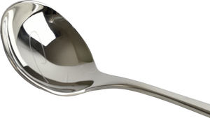 Close-up of the bowl of a stainless steel spoon, for cupping specialty coffee. It has the elegant Patricia 'P' etched into the bowl.