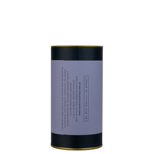 A navy blue cylinder with a purple label describes the filter coffee beans within.