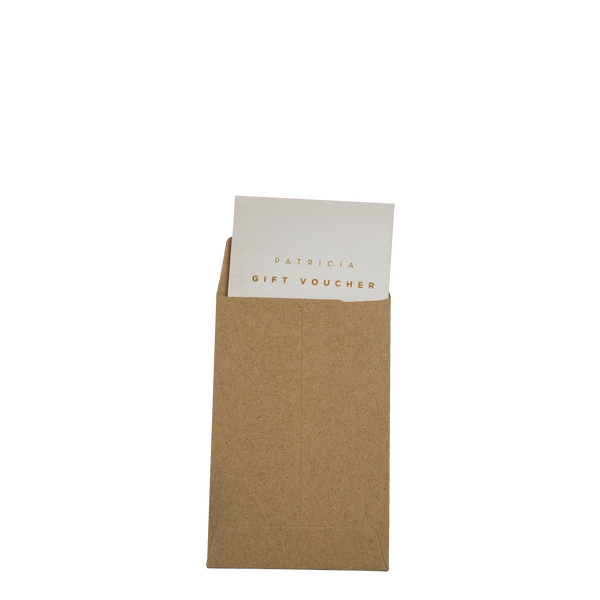 A white voucher card peaks out of a small brown paper pocket. It reads 'PATRICIA GIFT VOUCHER'.