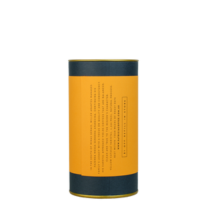 A navy blue cylinder with an orange label describes the roasted coffee beans within.