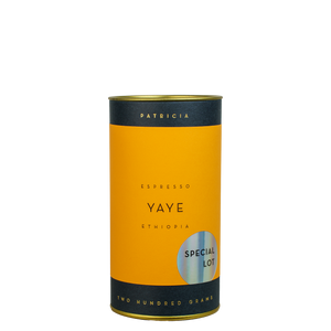 A navy blue cylinder with an orange label describes the roasted coffee beans within. 'PATRICIA' and 'TWO HUNDRED GRAMS' are printed in gold foil. A shiny round sticker reads 'SPECIAL LOT'