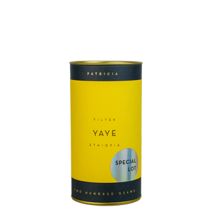 A navy blue cylinder with a yellow label describes the roasted coffee beans within. 'PATRICIA' and 'TWO HUNDRED GRAMS' are printed in gold foil. A shiny round sticker reads 'SPECIAL LOT'